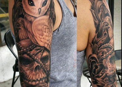 A woman with an owl and skull tattoo on her arm.