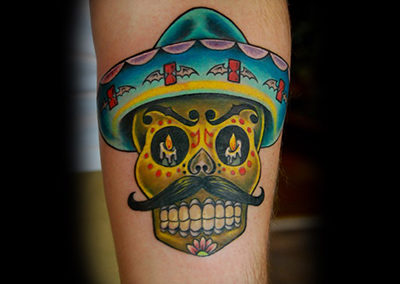 A tattoo of a skull wearing a hat and mustache.