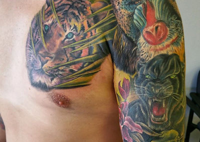A man with tattoos on his arms and chest.