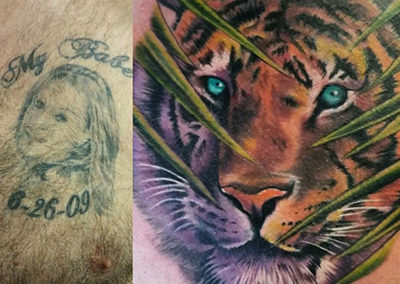 A tattoo of a tiger with blue eyes and a dog on the back.