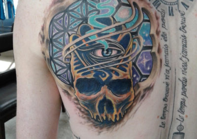 A man with a skull tattoo on his shoulder.