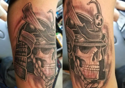 A tattoo of a skull wearing a helmet.
