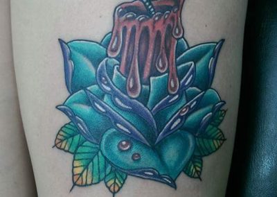A tattoo of a lotus and a melting candle