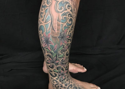 A man with tattoos on his legs and feet.
