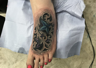 A woman 's foot with a tattoo of an octopus.