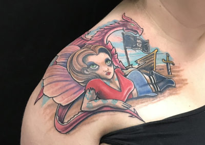 A woman with a tattoo on her shoulder.