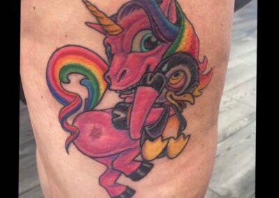 A pink unicorn with rainbow colors on its back