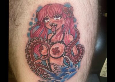 A tattoo of a woman with red hair and an octopus.