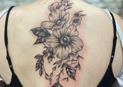 A woman with a tattoo of flowers on her back.