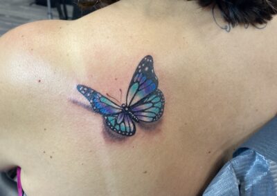 A woman with a butterfly tattoo on her back